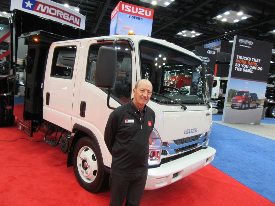Isuzu’s Bob Mooney greets attendees at the company’s display of work trucks engineered for a variety of applications.
