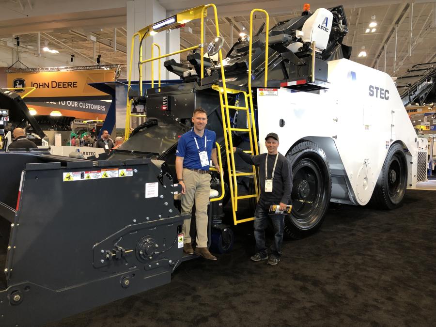 Kyle Neisen (L) of Astec and Brad Pitlik of Pitlik & Wick Inc. in Eagle River, Wis, stand with the Astec Shuttle Buggy 3000 material transfer vehicle (MTV). 