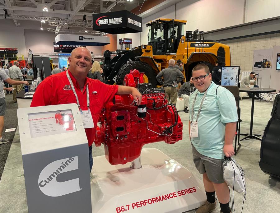 Casin Swann (L) and Caleb Swann of Pavement Restorations Inc. in Milan, Tenn., check out a Cummins engine. 