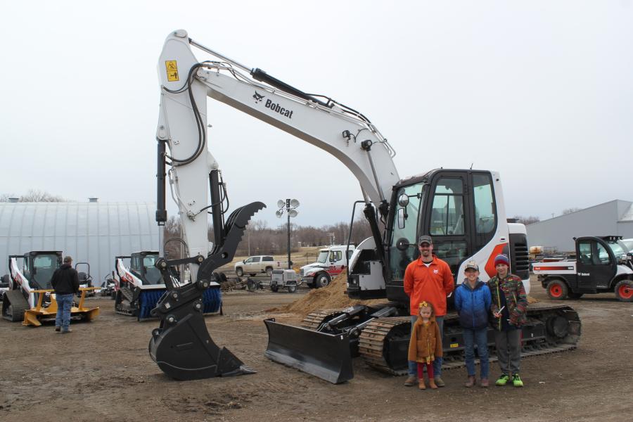 (L-R): Anthony Dragt, sales and rental, Farm-Rite Willmar, with his daughter, Leila, son, Blake, and friend, Silas Dykshoor, with one of Bobcat’s newest excavators: the E145.
