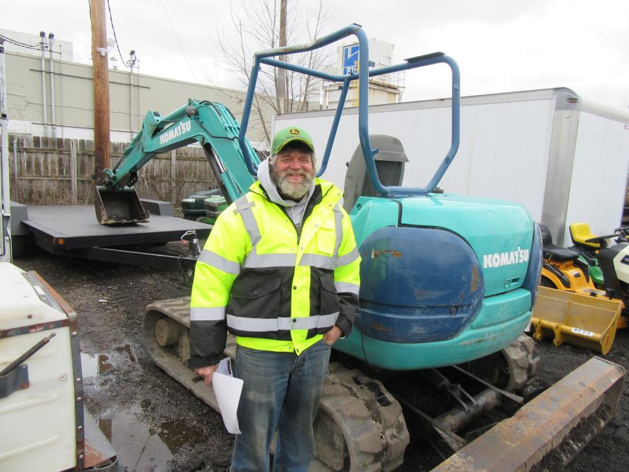 Keith Tompkins of Tomstead Farms considers a bid on the Komatsu PC40 mini-excavator.
