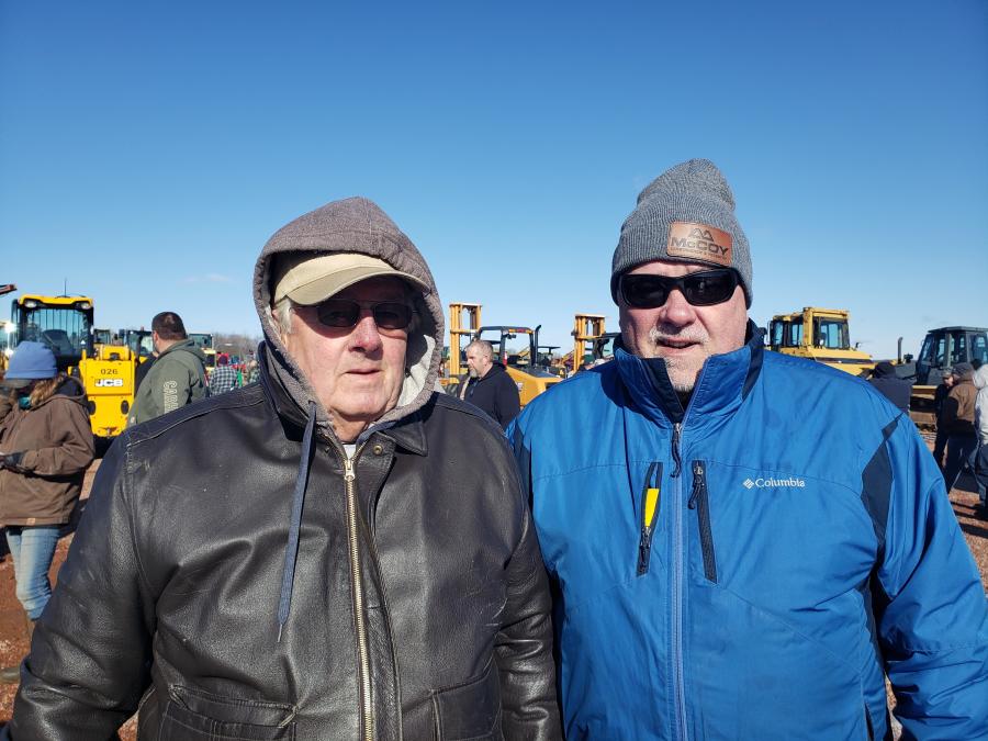 Comparing some notes on what the iron was going for at the spring sale are Les Hull (L), owner of Hulls 151 Implement, and Brian Durfee, corporate used equipment manager of McCoy Construction & Forestry.
