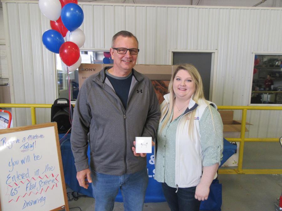 Door Prize drawing winner Mike McDaniel of Columbus received an Apple AirPod from Taylor Stimpert, Southeastern Equipment rental manager, at the Dublin open house. 
 