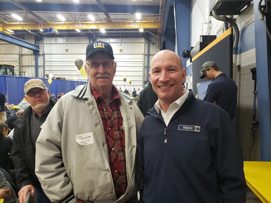 Lynn Fleishauer (L) of Fleishauer Cat and Backhoe Service talks with Dan Stevens, branch manager of Fabick Cat, Eau Claire.
