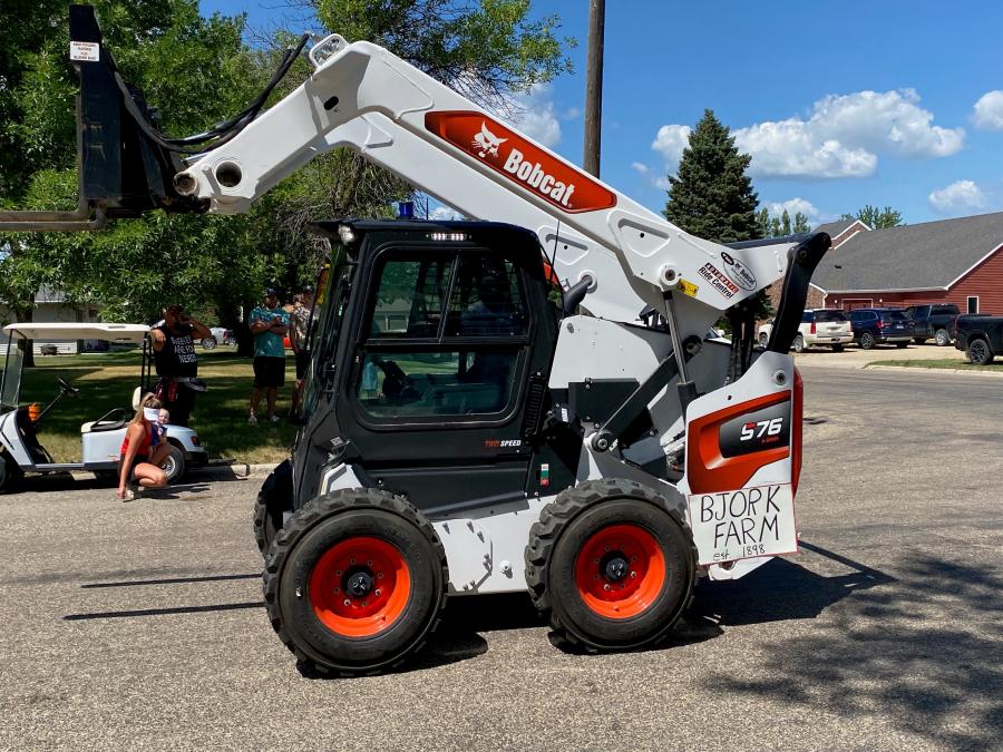 Brian Bjork remotely drove his Bobcat S76 skid steer loader equipped with MaxControl remote operation through the Gwinner Fun Days parade from inside the dealership pickup, following his unmanned machine.