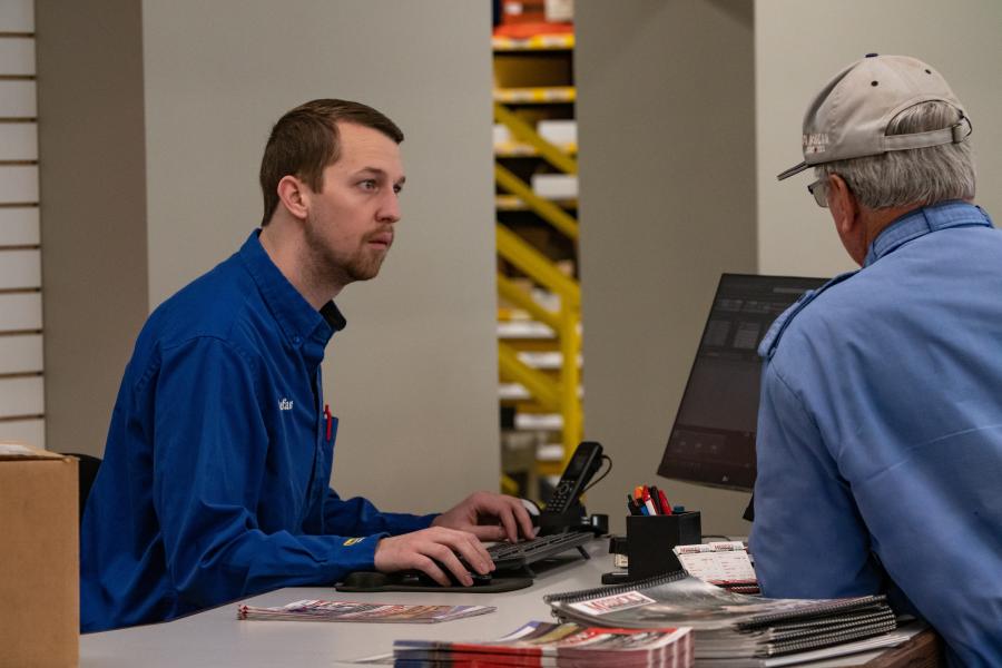 Stefan Heitz, a front counter parts technician, works with a customer.