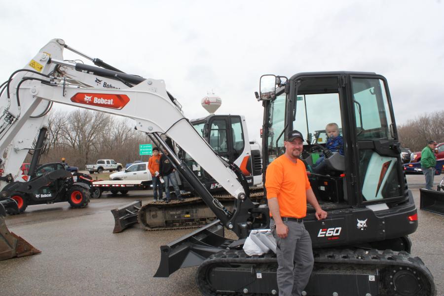 Erickson Wuollet of Howard Lake, Minn., and his son, Oliver, future excavator operator, check out this Bobcat E60 R2 series mini-excavator that was on display at the Dassel open house.
(CEG photo)