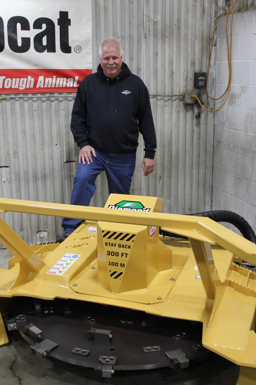 Paul Schreurs, regional sales manager of Diamond Mowers, with the SK Disc Mulcher Pro X at the St. Cloud event. This mulcher grinds down trees and brush efficiently and reliably. This attachment is available in a 48- or 60-in. cutting width and can mulch trees up to 6-in. in diameter.
(CEG photo)