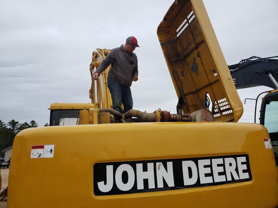 Brandon Buntrock checks the oil on this John Deere 892E LC excavator.
(CEG photo)
