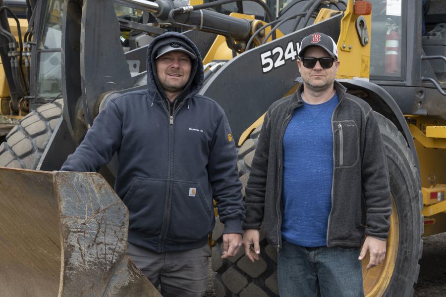 Brothers Ben (L) and Andrew Clemmey stand in front of a 2015 John Deere 524K wheel loader.
(CEG photo)