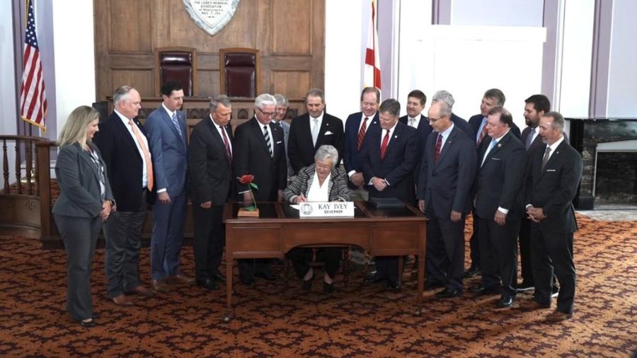 Gov. Kay Ivey signs a package of bills that approves new prison construction on Oct. 1, 2021. (Governor's Office/Twitter photo)