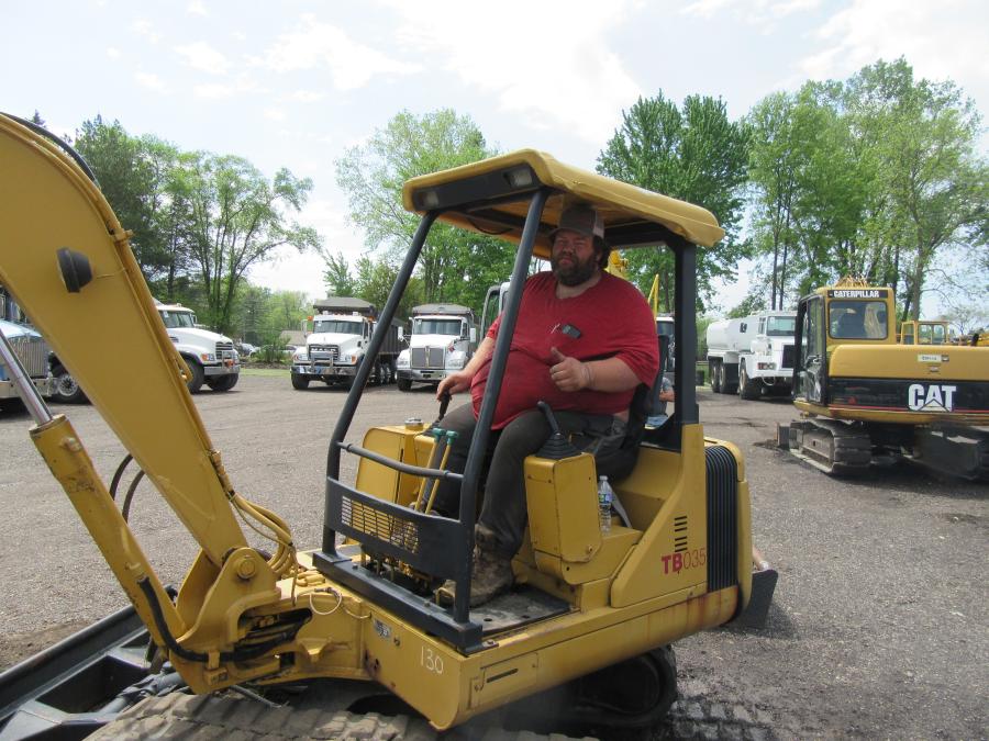 Nate’s Specialty Services’ Nate Clevenz puts this Takeuchi TB035 mini-excavator through its paces at the auction.
(CEG photo)