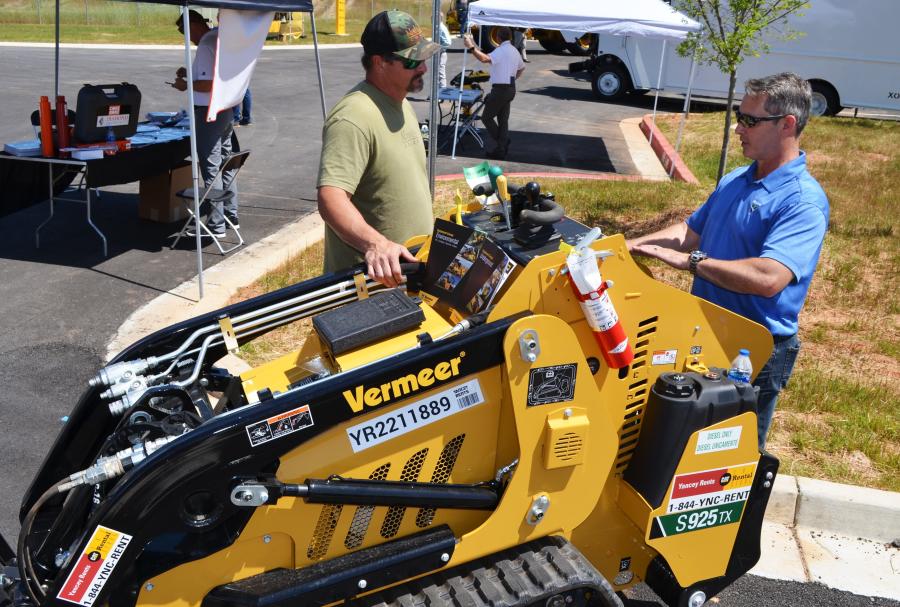 It was demo time for Bryan Jewell (R) of Vermeer Southeast, who was discussing the operation of a Vermeer S925TX mini-skid steer from the Yancey Rents fleet with an interested guest.    
(CEG photo) 