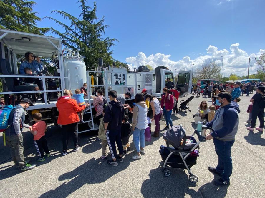 Kids and adults gather around a street painting truck at the 2022 Touch-A-Truck community event at Seattle’s Magnuson Park.
(SDOT photo)