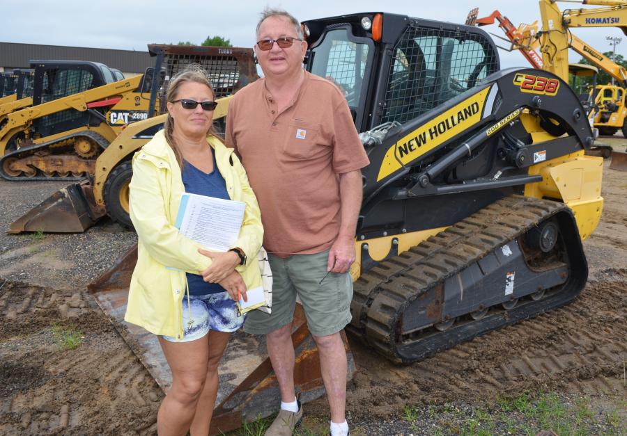 Jennifer Lindsey and David McCraw of Classic Truck & Equipment Sales, Cadiz, Ky., came to see about scoring some bargains on compact machines — including this New Holland C238 CTL.  
(CEG photo)