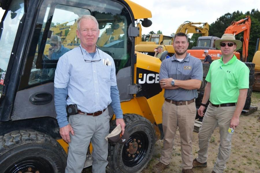 Checking out some of the compact equipment about to be auctioned, including this JCB 300 eco skid steer loader, (L-R) are Dale Harris, DBC Properties, Temple, Ga.; Craig Jacobs, WesPro JCB, Douglasville, Ga.; and Landon Harris, Olive Branch Properties, Temple, Ga.   
(CEG photo)