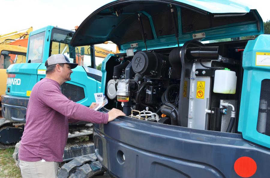 A couple of the new Sunward mini-excavators in the sale lineup had independent contractor Roy Shore, based in Murphy, N.C., taking a closer look.
(CEG photo)