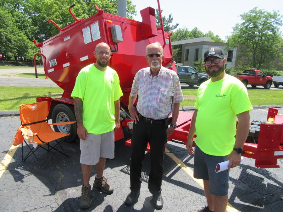 Larry Bragg (L) and Chuck Inzong (R) of the city of Bedford Heights spoke with The McLean Company’s Jim Hattendorf about adding this Falcon asphalt hot box and recycler to the city’s fleet. 
(CEG photo)