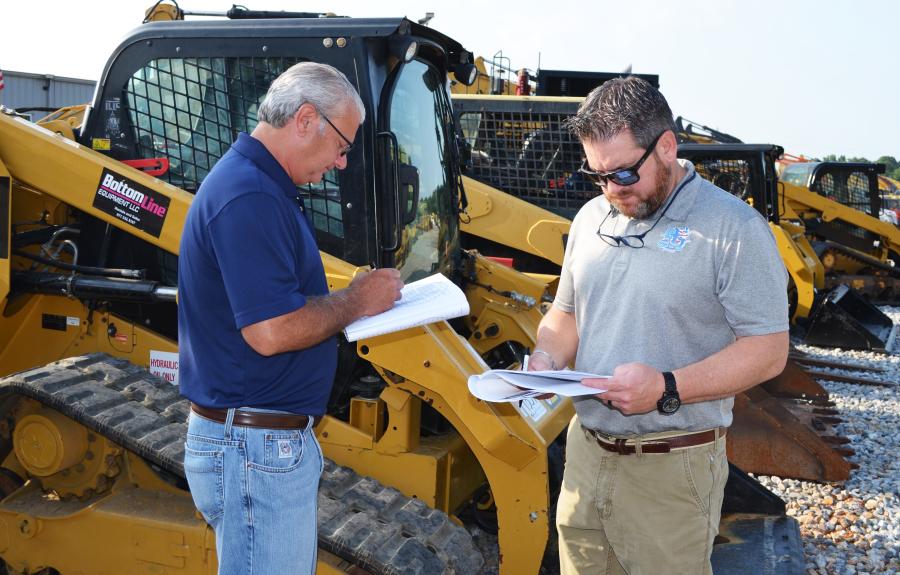 Researching several Cat compact track loaders for bidding consideration are Jeff Sampson (L) and Chris Deason of Riggs CAT, Little Rock, Ark.   
(CEG photo)