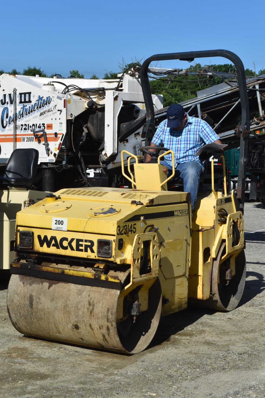 A Wacker Neuson double drum asphalt roller, ideal for a residential paving contractor, gets a test run before it goes on the block.
(CEG photo)
