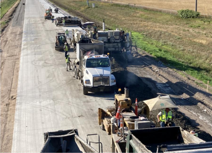 Crews and equipment work in sync as they pave the new third eastbound lane between Hwy 25 in Monticello and Wright Co. Rd. 8 in Hasty. Concrete is delivered in the front end and newly paved lanes are seen on the back end.
(Andrew Borders, MnDOT field inspector photo)