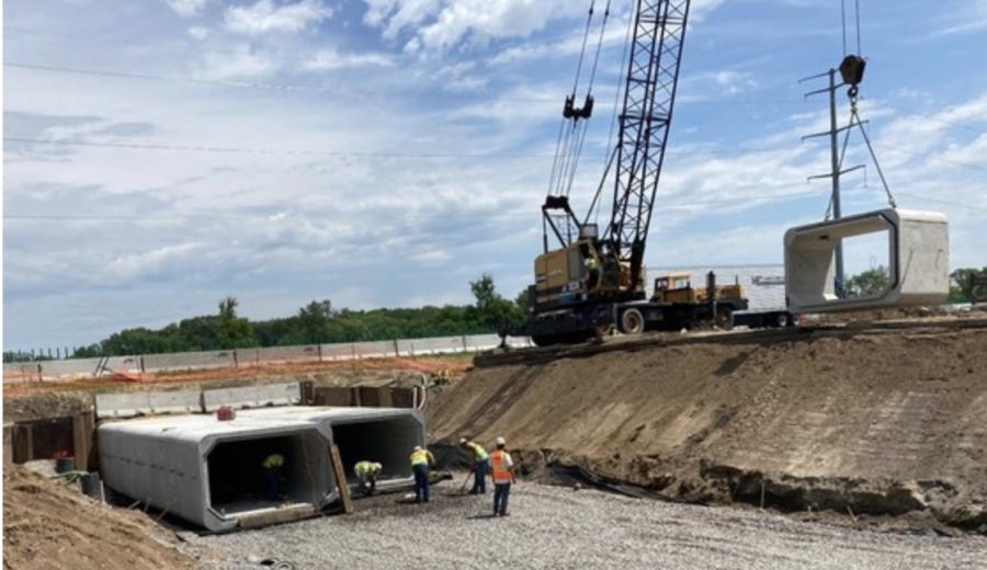 A crane lifts a box culvert section into place at the Silver Creek under eastbound I-94.
(Andrew Borders, MnDOT field inspector photo)