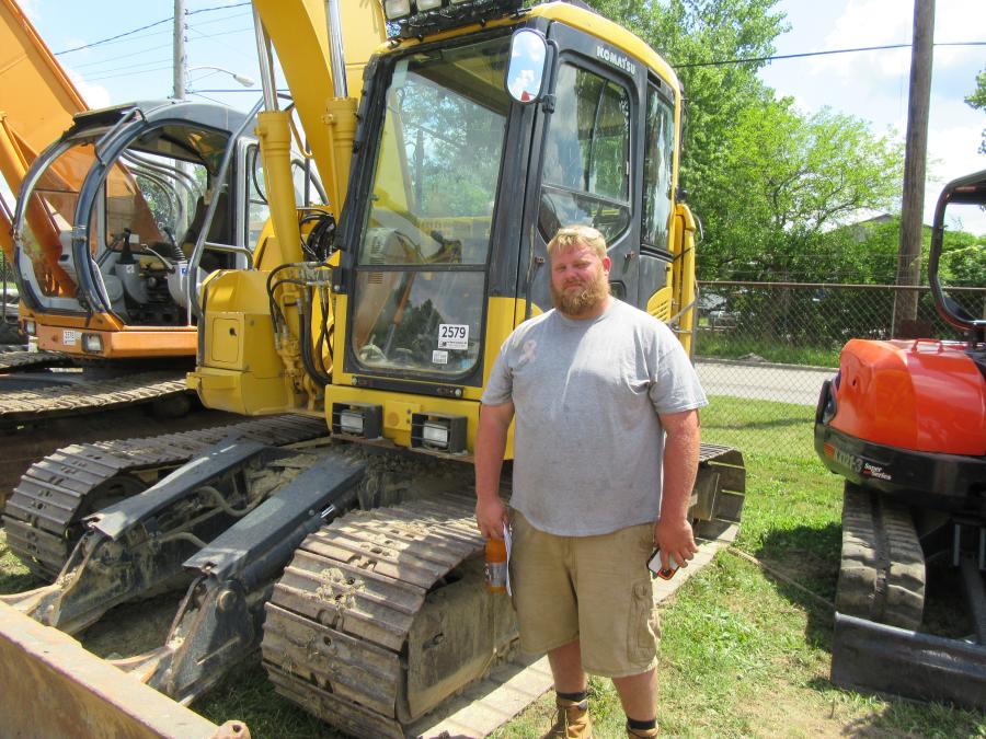 David Walton of Scarlet and Grey Lawn Care Management reviews the excavators.
(CEG photo)