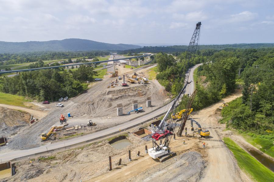 The job called for 2,233,411 cu. yds. of unclassified excavation and 2,691,692 cu. yds. of compacted embankment. Cranes, backhoes, dozers and dump trucks have been required to perform the work. Concrete, steel, reinforcing steel, aggregate base and asphalt are among the chief materials being used.
(Arkansas DOT photo)