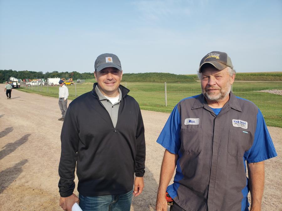 John Theorin (L) of Wausau Auctioneers talks with Mitch King of King Gravel and Excavating in Atley, Wis. (CEG photo)
