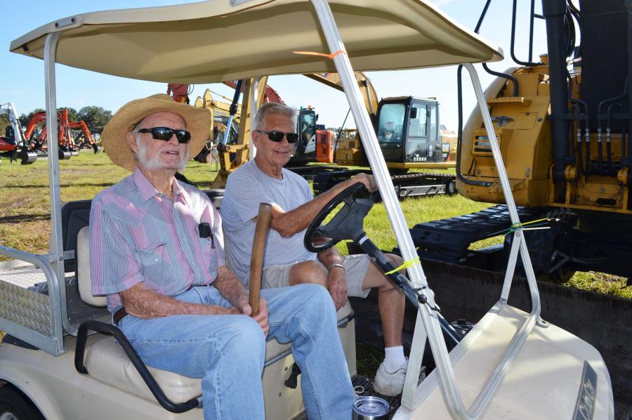 Golf carting around the lot looking for the next machine of interest are Jim Maggard (L) of Lake Wales, Fla., and Ted Gleave, of Kitto Sheds & Equipment, Lake Hamilton, Fla. (CEG photo)
