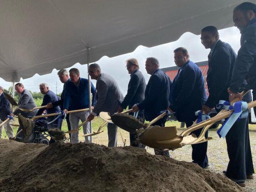 A delegation of local, state and federal officials take a shovel full of ceremonial dirt during a ground-breaking ceremony at the South Quay Marine Terminal. (Photo courtesy of Gov. Dan McKee)
