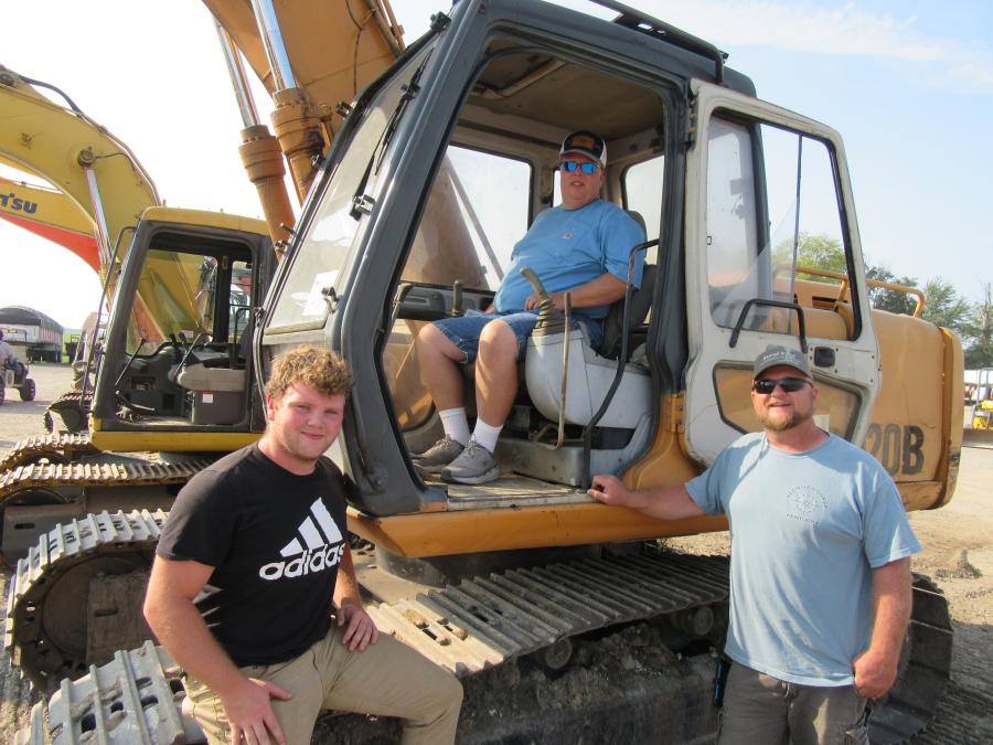 (L-R): Dakota, Tres and Jason Milton of H.D. Milton Jr. & Sons were in from Cincinnati to consider a bid on this Case 9020B excavator. (CEG photo)