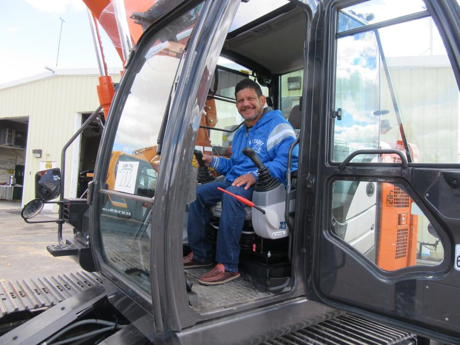 JC-Contractors’ Julio Garcia tries out this Hitachi ZX135US excavator.
(CEG photo)