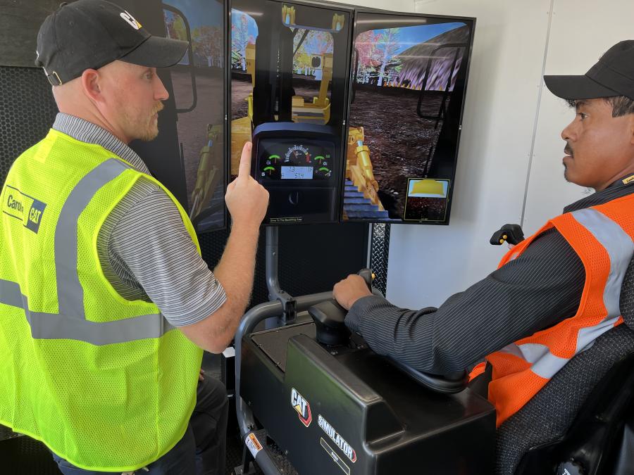 Aaron Adams (L) of Carolina Cat goes over the Cat dozer in the mobile operator training center with Herminio Garcia of Spartan Site Services in Charlotte.
(CEG photo)