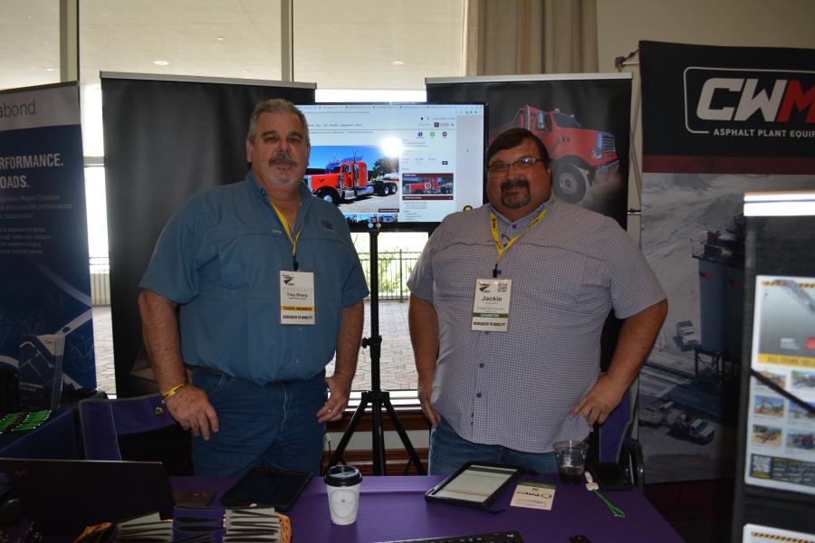 Trey Sharp (L) and Jackie Black answered attendees’ questions about Purple Wave’s no-reserve online auction service that specializes in selling heavy construction equipment. (CEG photo)