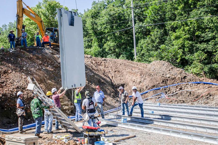 Workers make preparations for the installation of a Fast Cast bridge near the W.W. Keeler Tribal Complex on Bald Hill Road that was damaged during catastrophic flooding in May.
(Cherokee Nation photo)