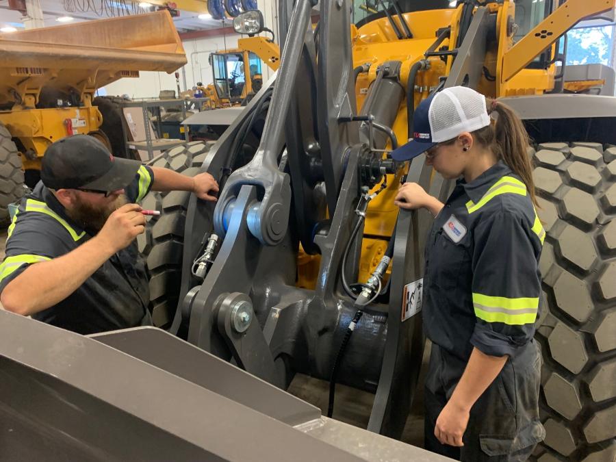 J-Tech Institute graduates and Alta Equipment Company technicians TJ Wright and Tiffany Roberts examine a wheel loader at Alta’s Jacksonville, Fla., location.