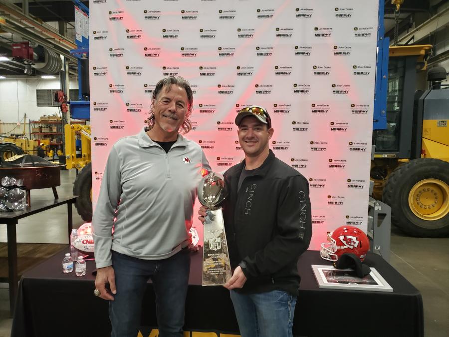 Jarred Dick (R) of Encore Pavement in Wichita, Kan., holds the Super Bowl trophy, brought by Mike Bell, former Chief’s defensive end and now a Kansas City Ambassador. (CEG photo)