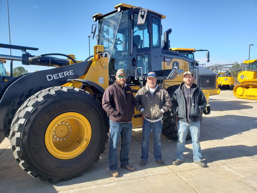 (L-R): Drew Turner of Murphy Tractor talks with Tim Lubbers and Chris Egbert, both of Lubbers Excavating, about this John Deere 644 wheel loader. (CEG photo)