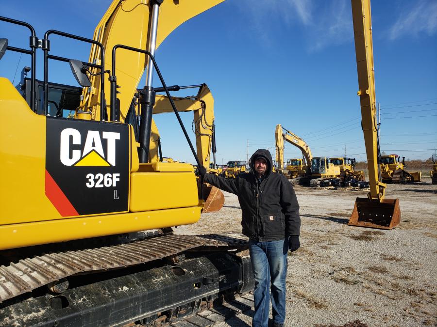 Standing beside this Cat 326F long reach excavator is Jameson Sheley of Byrne and Jones Construction. (CEG photo)
