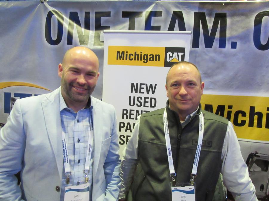 Josh Buchanan (L) and Wes Holt welcome attendees to discuss Caterpillar equipment at the Michigan CAT booth.
(CEG photo)