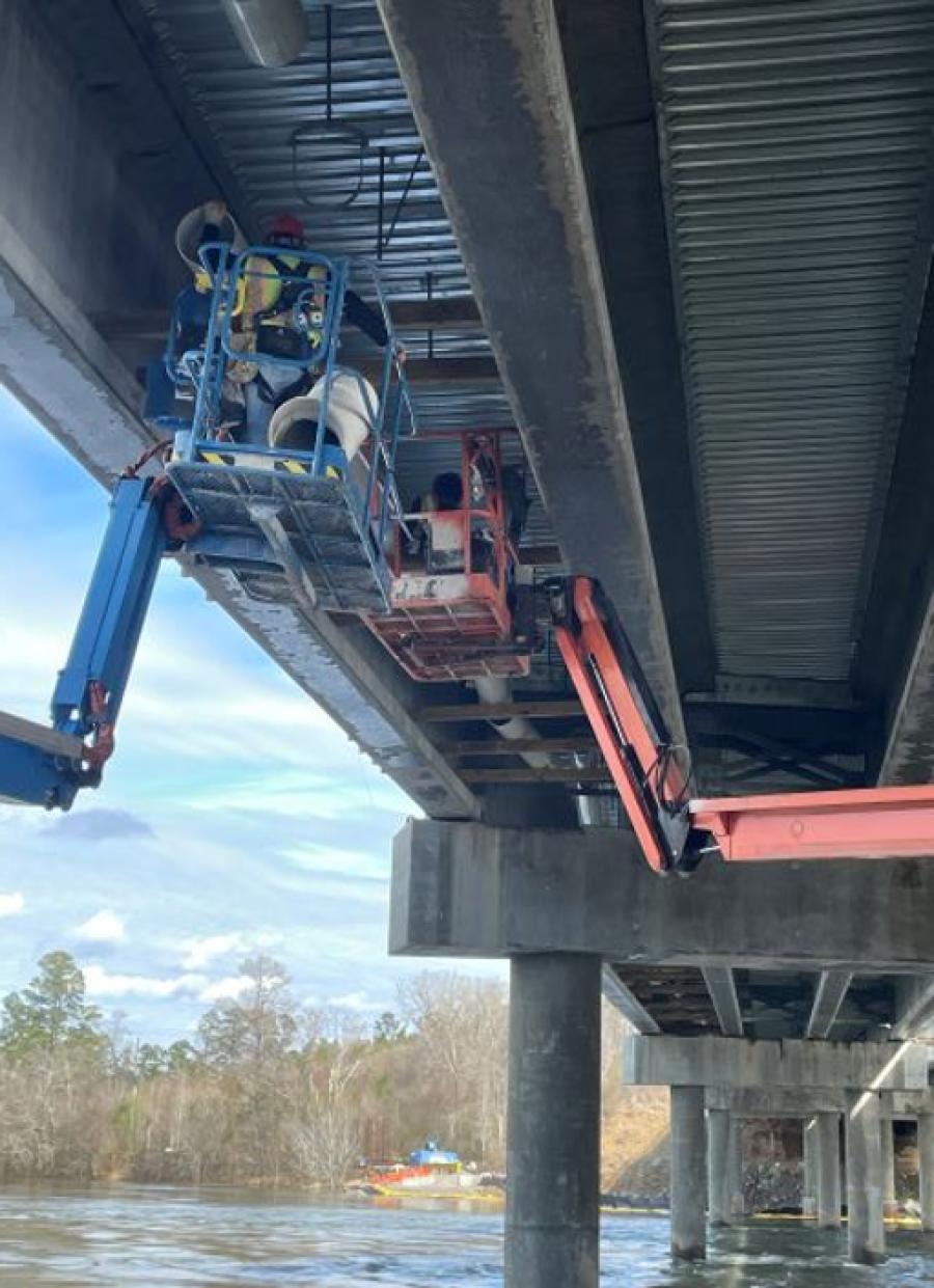 Workers install a scupper drain pipe. (Photo courtesy GDOT)