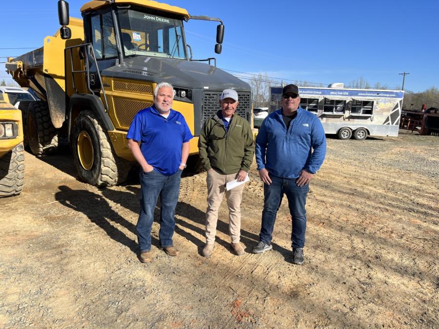 (L-R): Matt McGaffee and Ross McMillan, both of Iron Auction Group, and Shane Ferguson of Cardinal Concrete in Midland, N.C., looked over some of the equipment before the auction began.
(CEG photo)