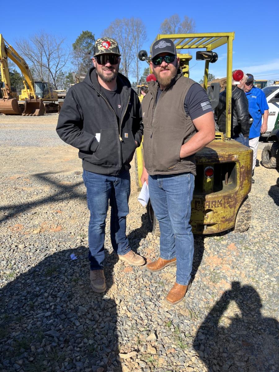 Jake Pressley (L) of Pressley Development in Hemby Bridge, N.C., and Russell Griffin of Ironpeddlers in Monroe, N.C., caught up at the auction.
(CEG photo)