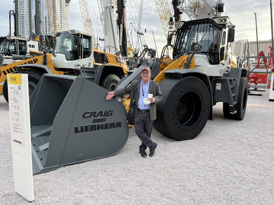 Craig Mongeau, editor-in-chief of Construction Equipment Guide poses with the new Liebherr bucket — not really named after him.  