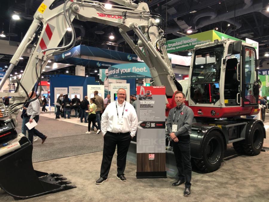 David Caldwell (L), national product manager, and Stephen Odum, national marketing manager, both of Takeuchi, stand in front of the TB395W wheeled excavator, which is designed with road and bridge contractors in mind and will be available in North America in Fall 2023. 