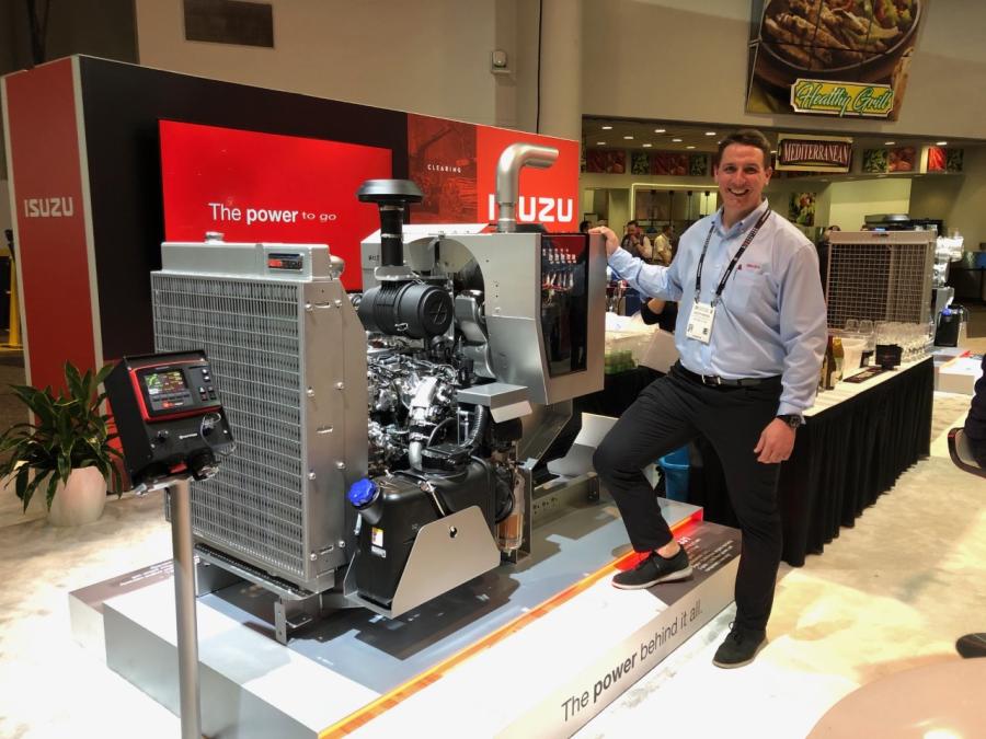 Scott Noyes, manager of technical sales of Isuzu, standing in front of the 4JJ1 pre-validated open genset power unit. 