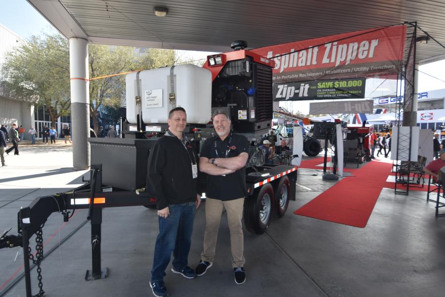 Jason Paas (L), area sales and training manager and Merl Guth, factory sales manager of Asphalt Zipper in front of the 36-in. Zipper, Tier V, 200 hp “Hot Rod” trencher. This unit is a very powerful, versatile and affordable loader attachment. It can pulverize up to 12-in.-thick asphalt in a single pass. Works for road repairs, base stabilization, street patches and opening utility trenches in asphalt.  
