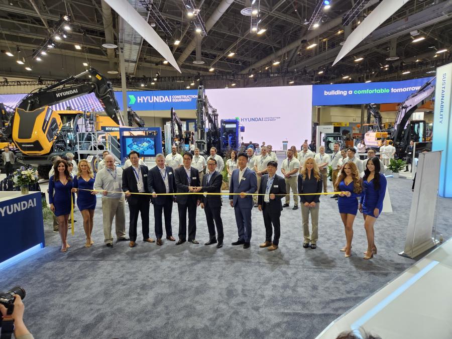Hyundai Construction Equipment executives cut the ribbon to open their display at ConExpo 2023 in Las Vegas. 