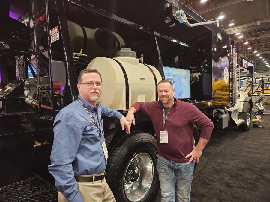 Randy Tattershall (L) of Etnyre International in Oregon, Ill., gives Matthew Porter of Porter Brothers in Rock Falls, Ill., the details on Etnyre’s Road Saver microsurfacing machine. 